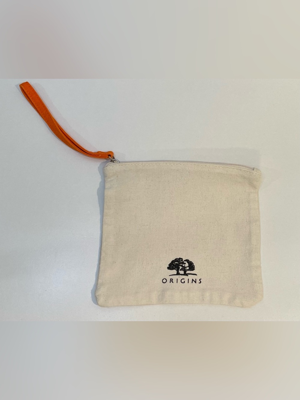 Origins Natural Canvas Wristlet with Orange Strap and Black Logo